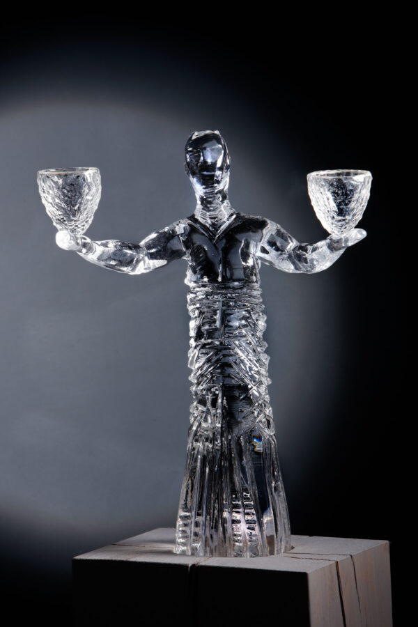 figurative glass art piece by allister Malcolm which is a male figure holding two glass vessels with arms outstretched