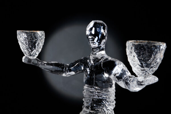 figurative glass art piece by allister Malcolm which is a male figure holding two glass vessels with arms outstretched