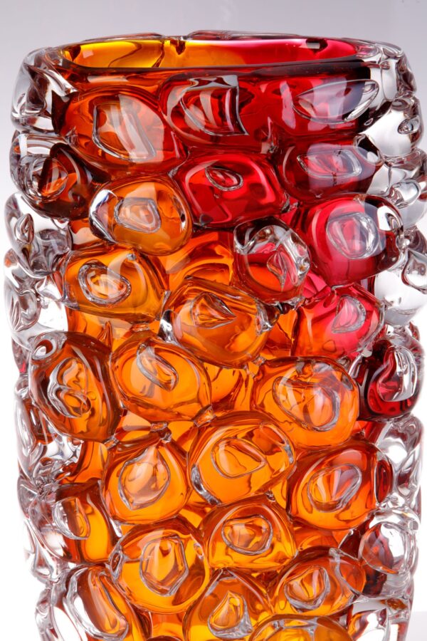 A glass vase completely covered on glass bubbles looks very tactile with rich red and warm orange colours for sale in the shop on the website