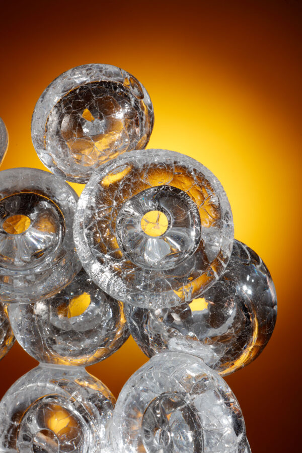 detail of a collection of thick glass bubbles joined together to form a beautiful sculpture, each bubble has a crackled surface