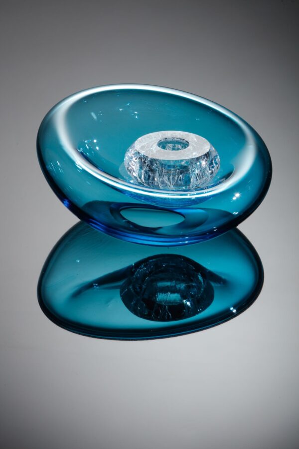 a crackled glass bubble sits within what looks like a glass cushion in aquamarine to form a glass sculpture for sale by Allister Malcolm