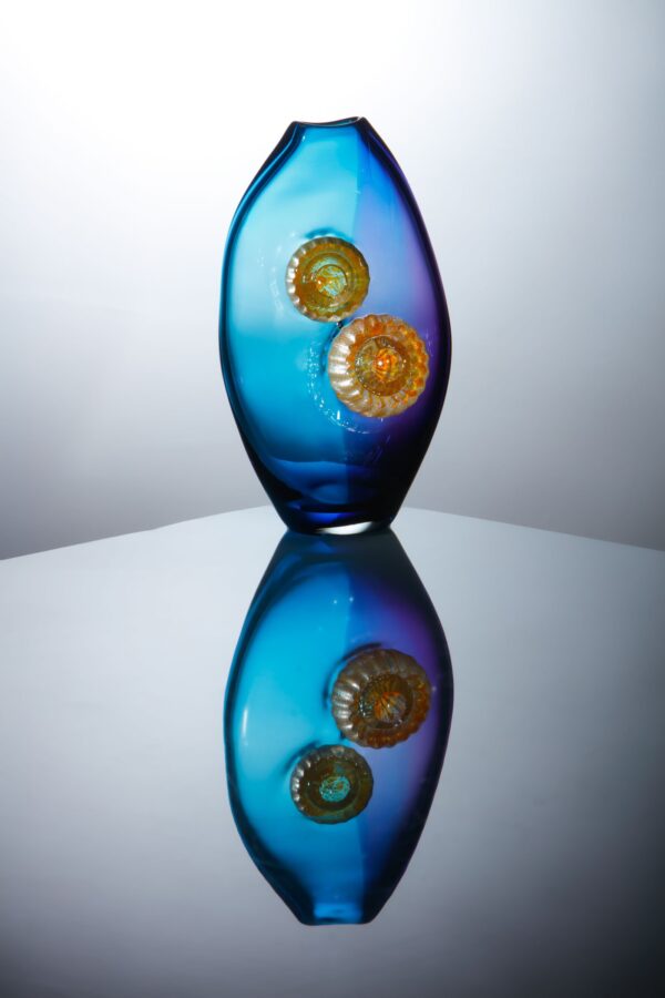 aqua marine and amethyst coloured vessel or vase with silvery details mounted on the surface creating a unique glassart work, for sale on the website