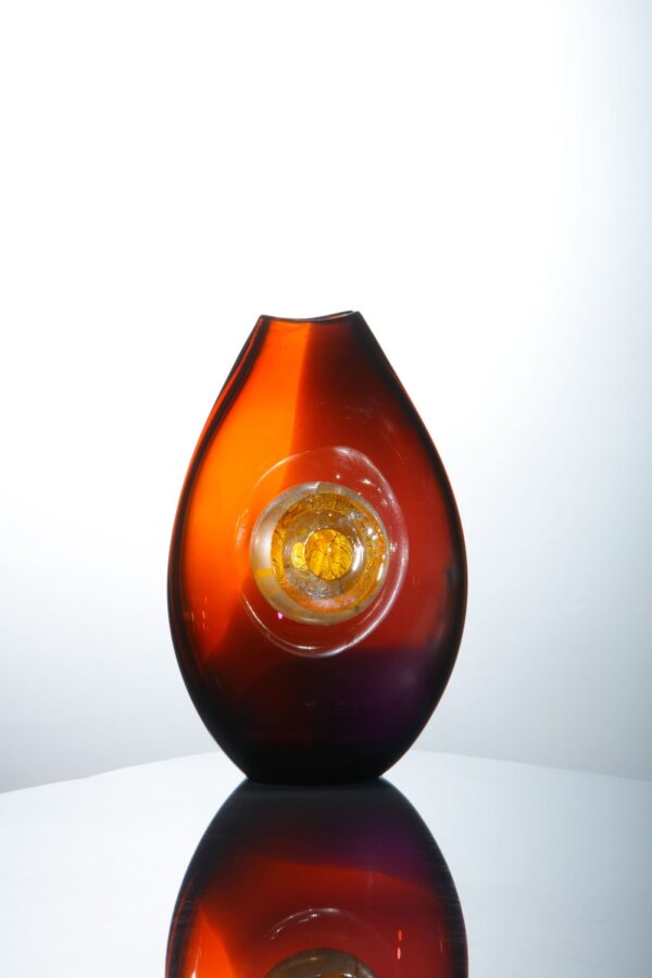 a single vase glows beautifully with a warm energy due to the tones of red and amethyst in this piece of glassart by Allister Malcom for sale on the website