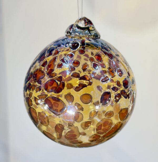 a handmade Christmas bauble with aqua speckles and silvery gold made in England at Stourbridge glass museum and for sale on the website